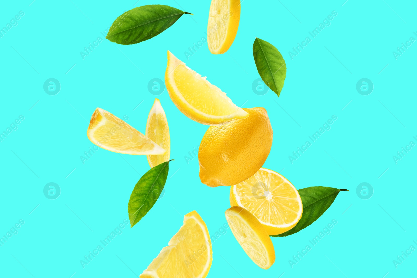 Image of Fresh ripe lemons and green leaves on cyan background