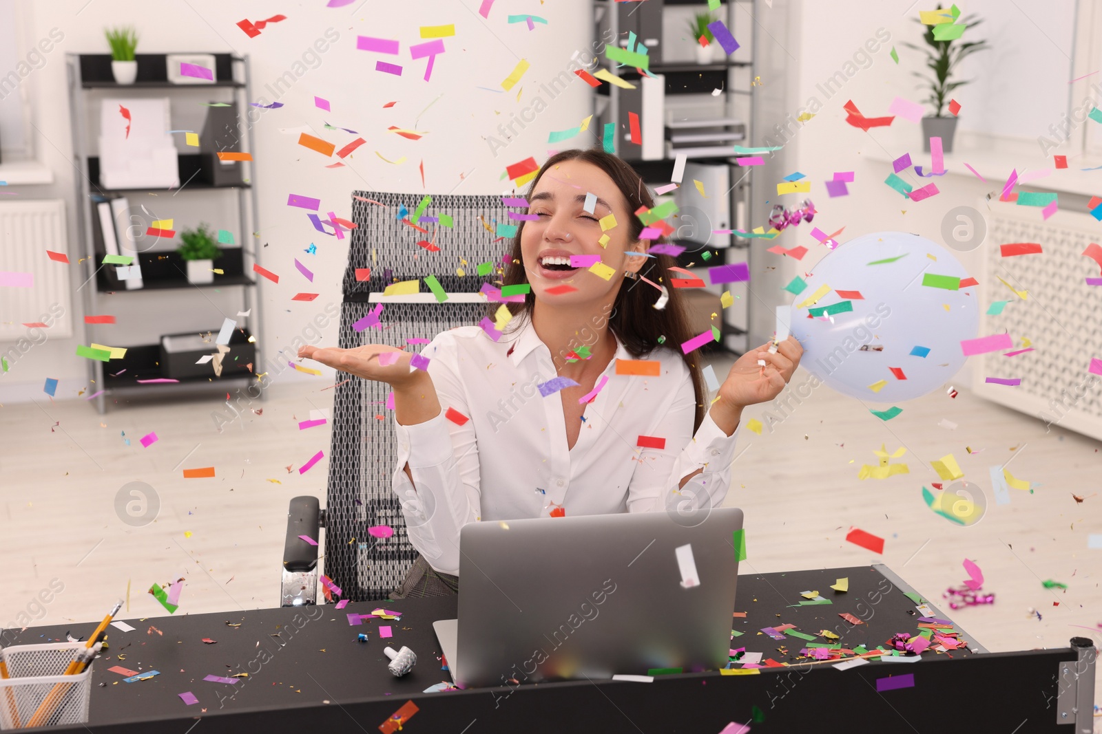 Photo of Young woman having fun during office party at workplace