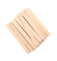 Photo of Disposable wooden spatulas for depilatory wax on white background, top view