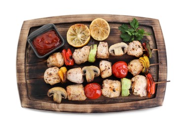 Photo of Wooden board with delicious shish kebabs, tomato sauce and grilled vegetables isolated on white, top view