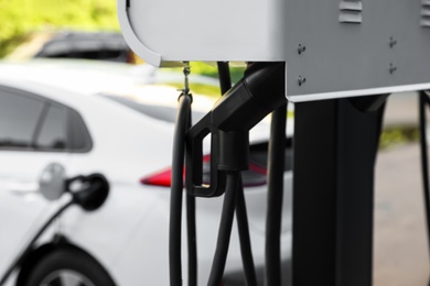 Photo of Electric vehicle charging station outdoors, closeup view