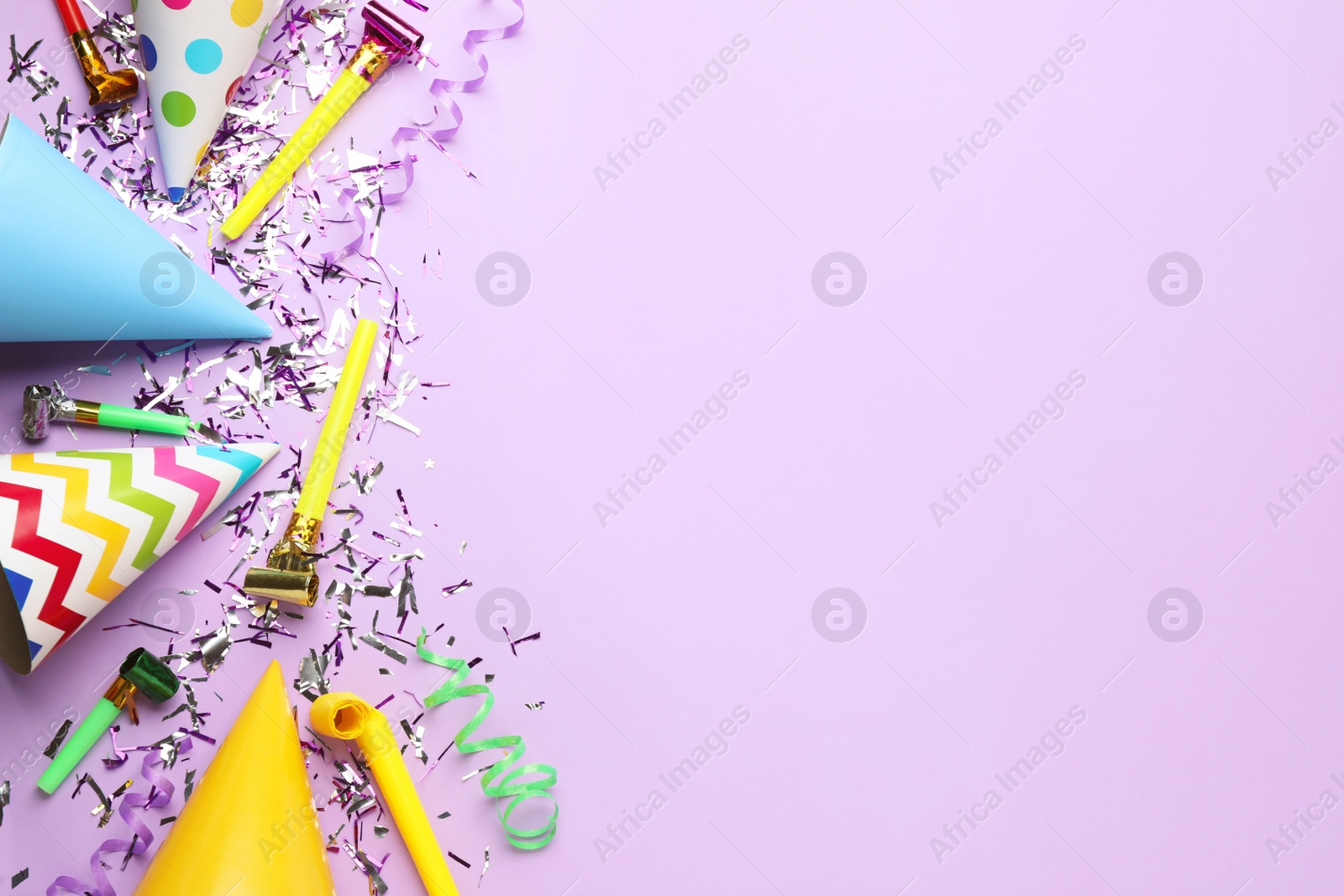 Photo of Beautiful flat lay composition with festive items on violet background, space for text. Surprise party concept