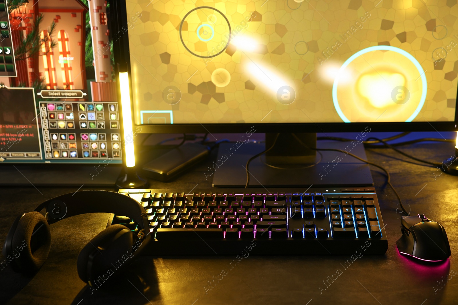 Photo of Playing video games. Computer monitor, keyboard, mouse and headphones on table indoors