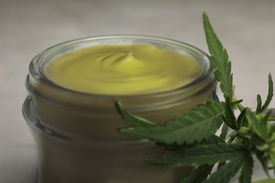 Photo of Jar of hemp cream on table, closeup. Organic cosmetics