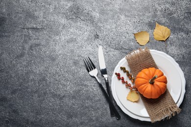 Photo of Festive table setting with autumn decor on grey background, flat lay. Space for text
