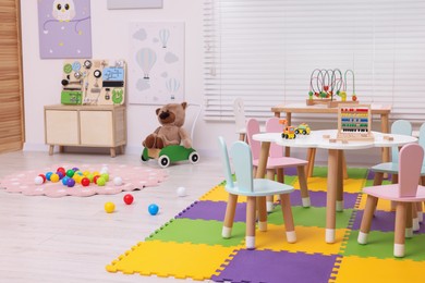 Stylish kindergarten interior with toys and modern furniture