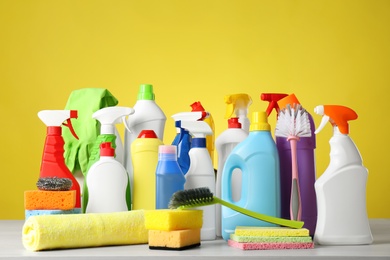 Photo of Different cleaning products and supplies on light table