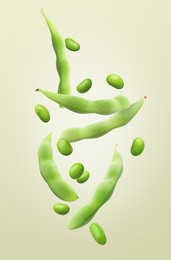 Image of Fresh edamame soybeans and pods falling on color background