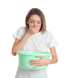 Photo of Woman with basin suffering from nausea on white background. Food poisoning