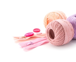 Photo of Color threads and sewing accessories on white background