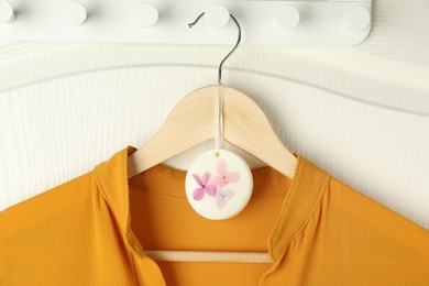 Scented sachet with flowers and stylish clothes on hanger