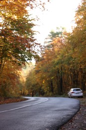 Photo of View of car parked near beautiful autumn forest