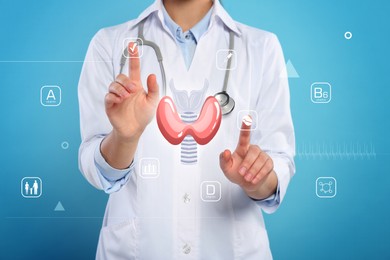 Image of Diagnosis and treatment of thyroid diseases. Endocrinologist using virtual screen with thyroid gland and icons on light blue background, closeup