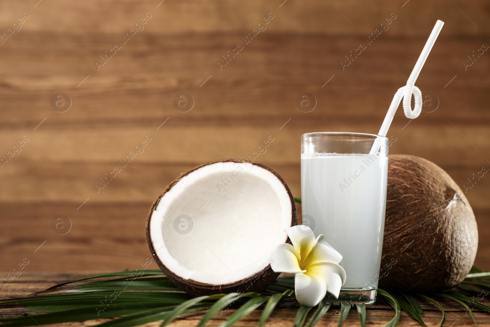 Photo of Composition with glass of coconut water on wooden background