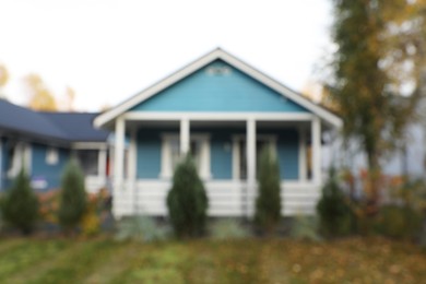 Blurred view of beautiful light blue houses outdoors. Real estate