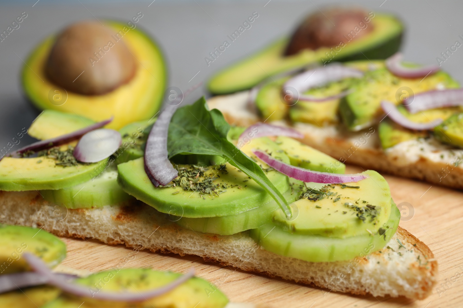 Photo of Tasty toasts with avocado on table, closeup