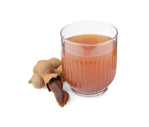 Photo of Glass of tamarind juice and fresh fruits isolated on white