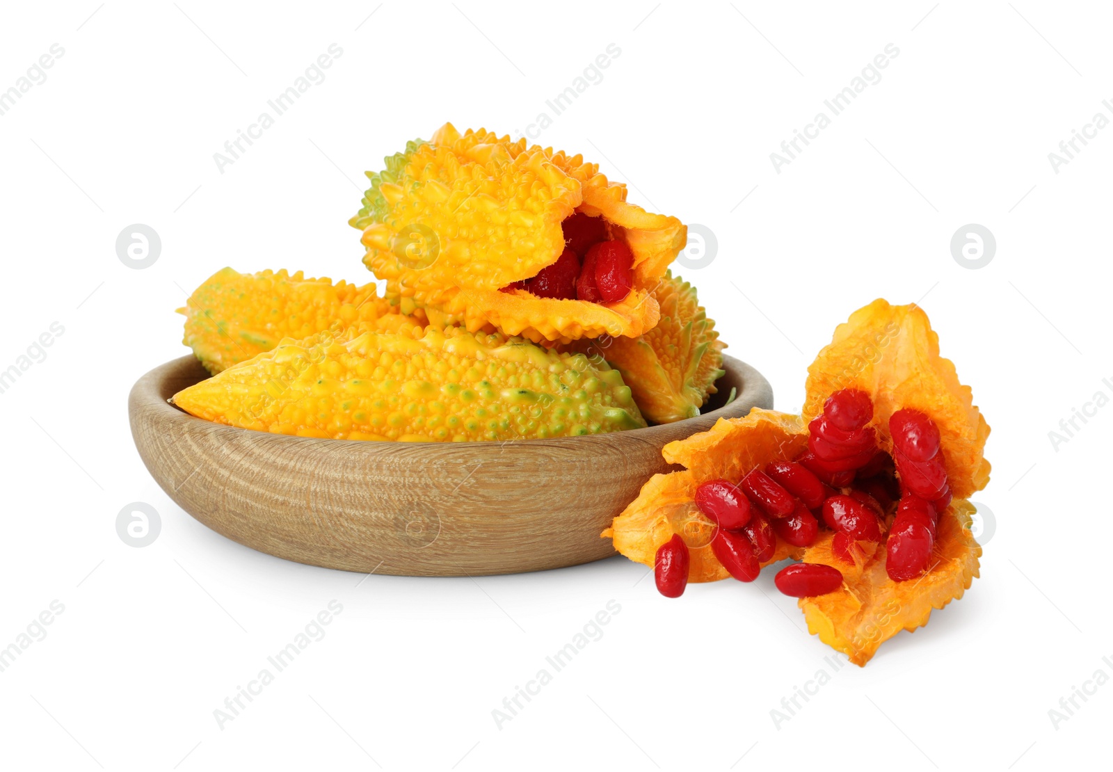 Photo of Wooden bowl with fresh ripe bitter melons on white background