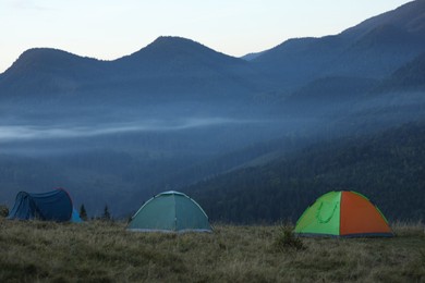 Photo of Camping tents in mountains on early morning