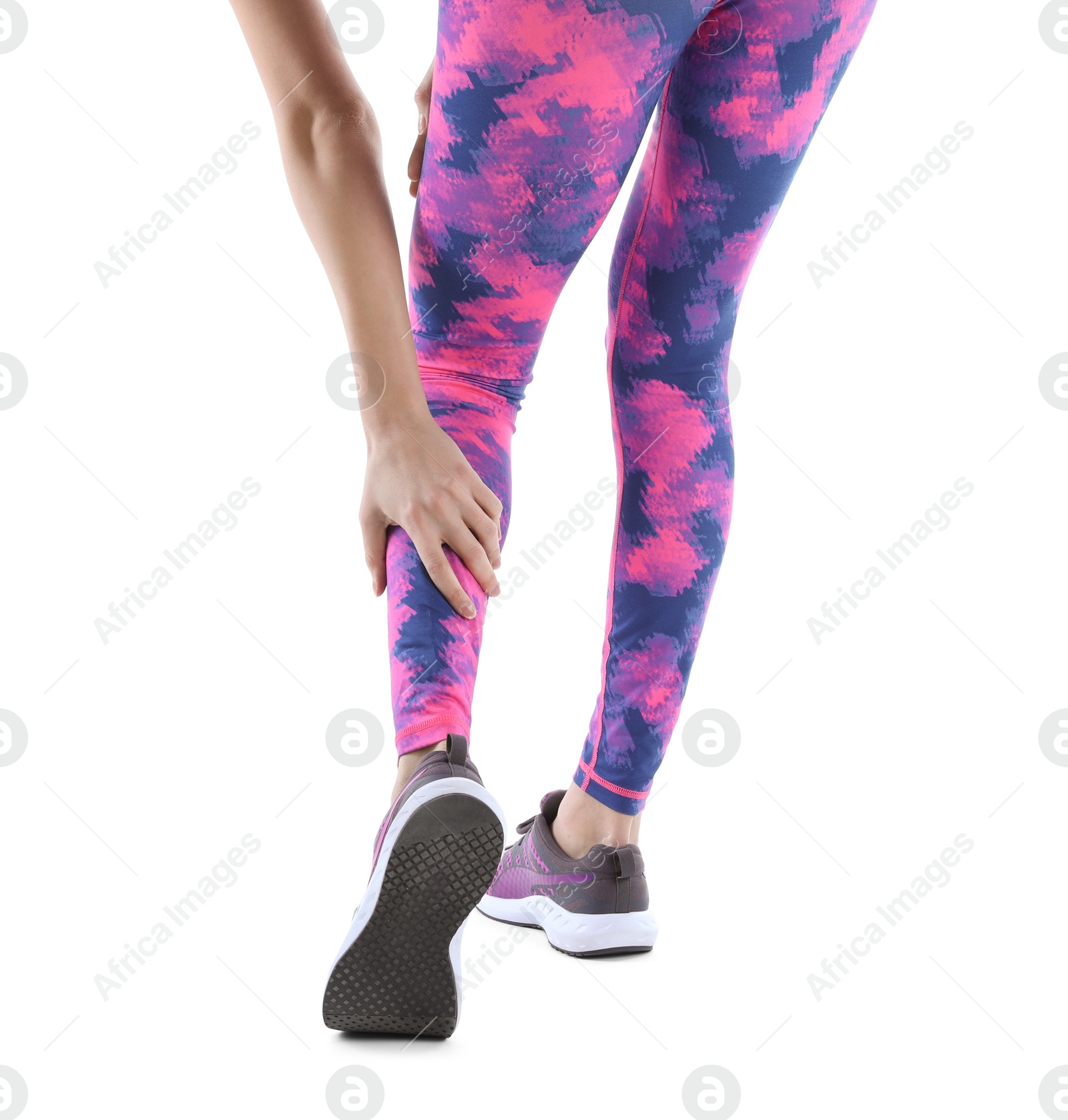 Photo of Young woman suffering from leg pain on white background, closeup