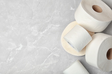 Toilet paper rolls on grey background, top view. Space for text