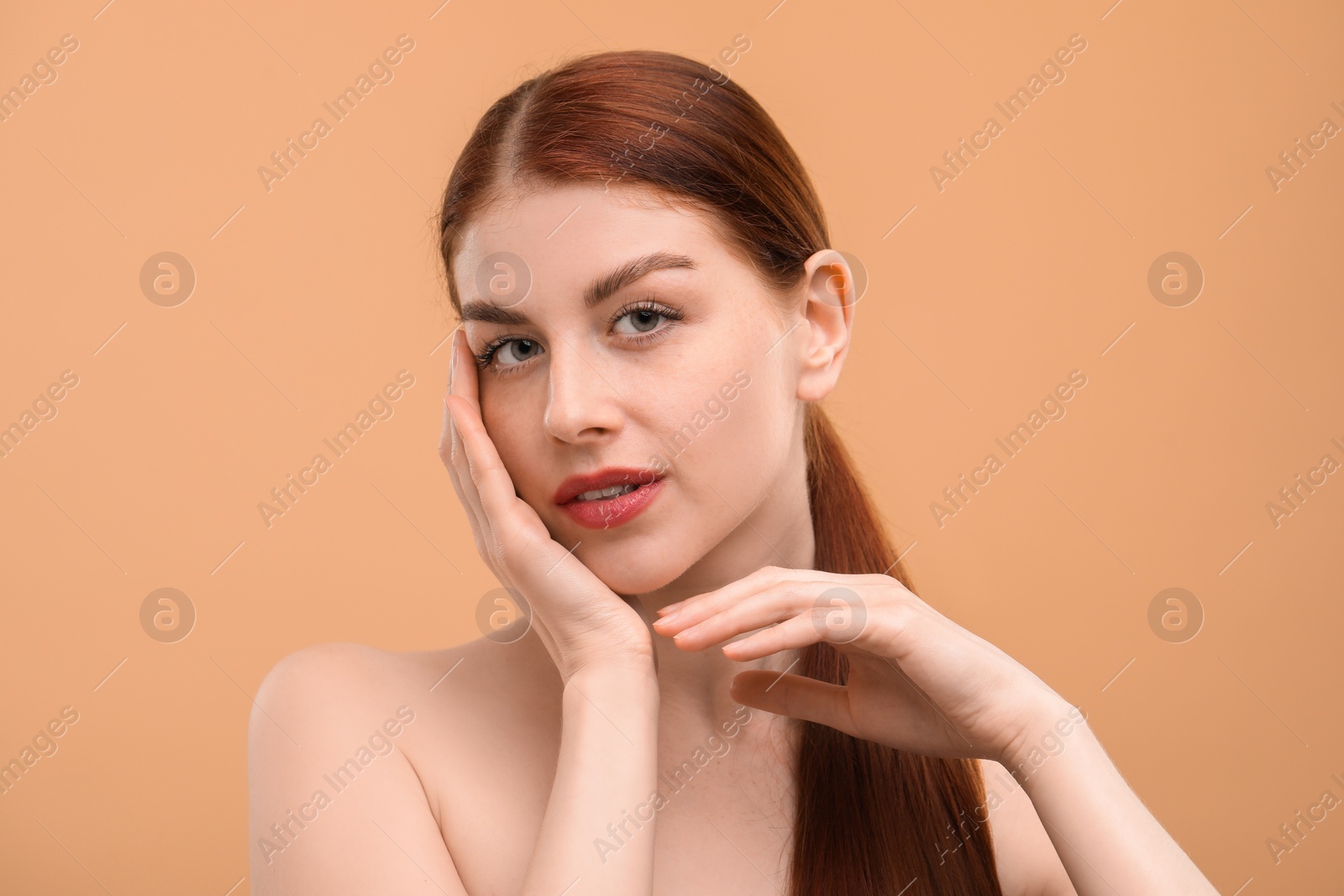 Photo of Portrait of beautiful woman with freckles on beige background