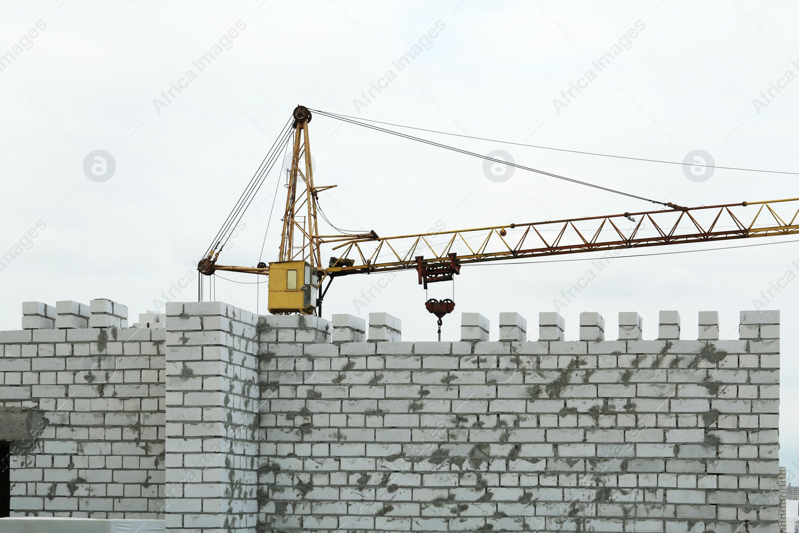 Photo of Construction site with tower crane near unfinished building