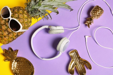 Photo of Flat lay composition with pineapple in sunglasses and headphones on color background