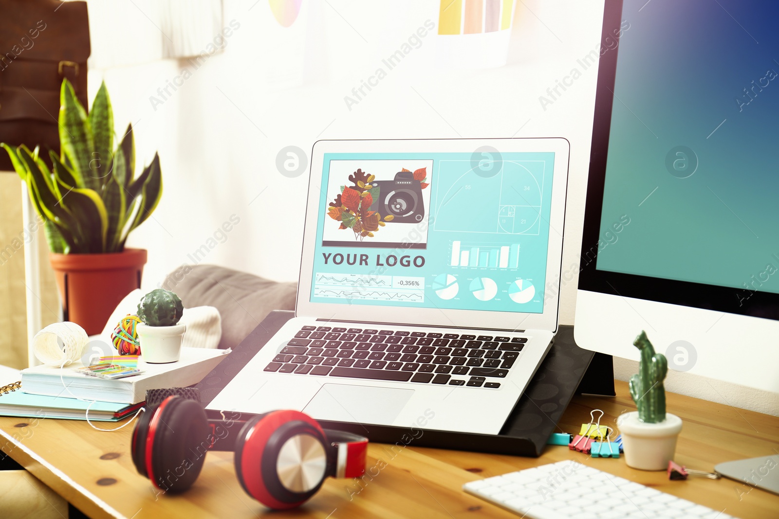 Image of Modern designer's workplace with laptop in office