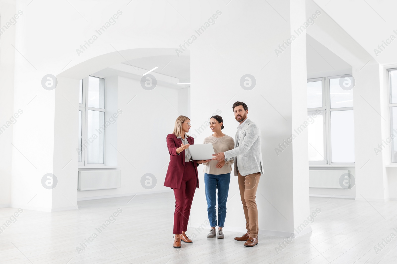 Photo of Real estate agent showing new apartment to couple