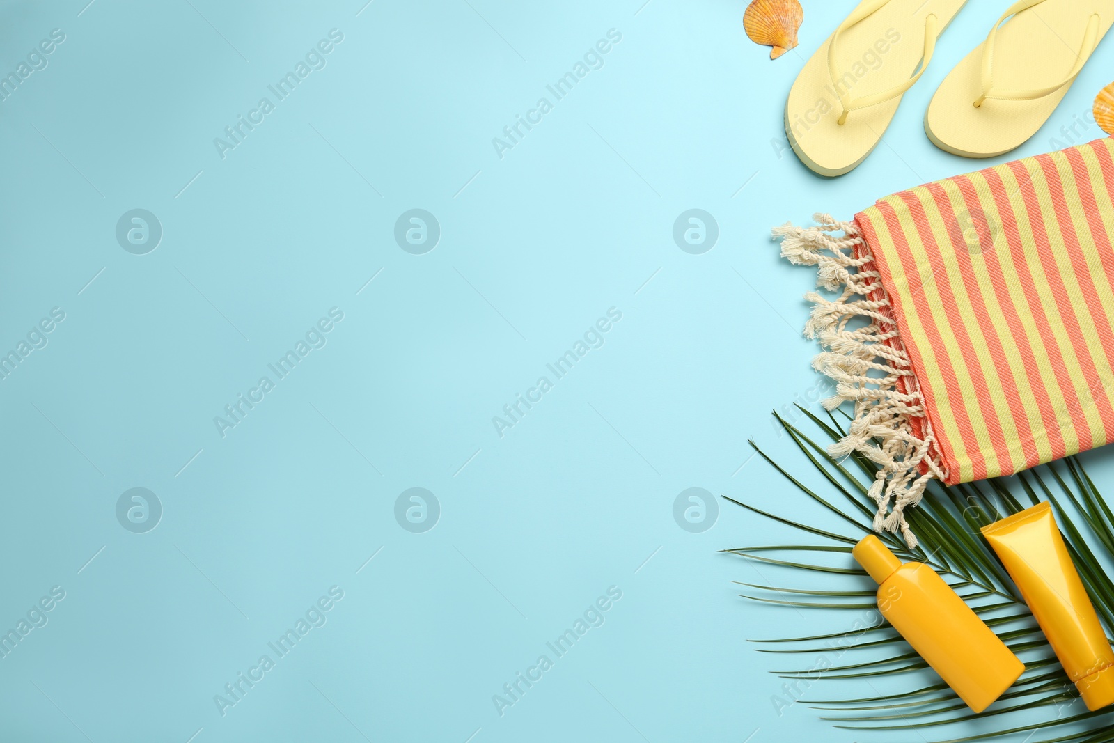 Photo of Flat lay composition with different beach objects on light blue background, space for text