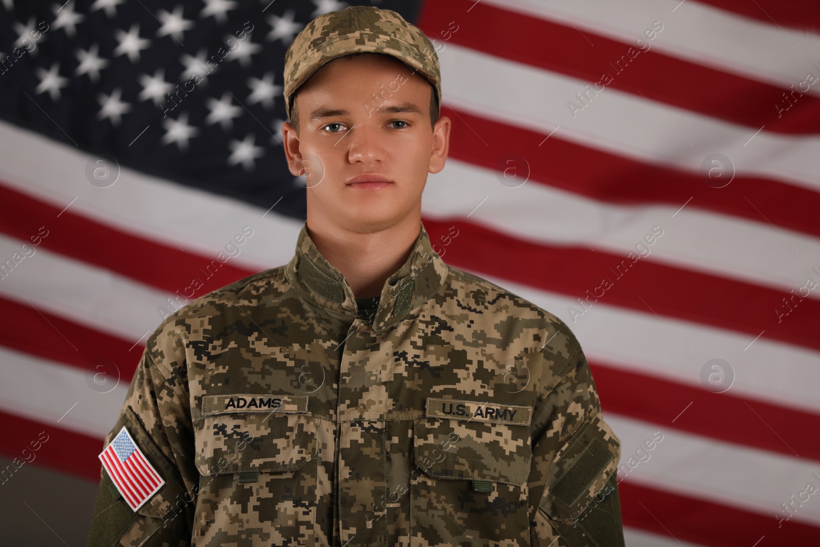 Photo of Male soldier and American flag on background. Military service