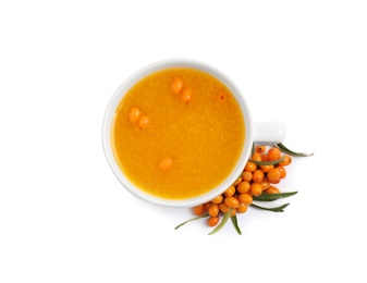 Photo of Sea buckthorn tea and fresh berries isolated on white, top view