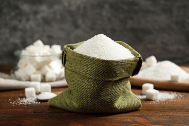 Granulated sugar in sack on wooden table