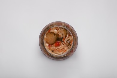 Photo of Jar of tasty pickled vegetable salad on white background, top view