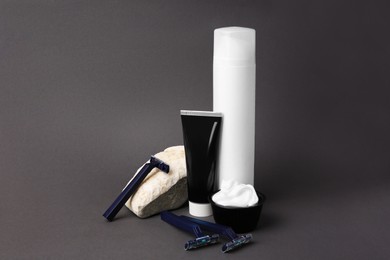 Photo of Different men's shaving accessories on grey background