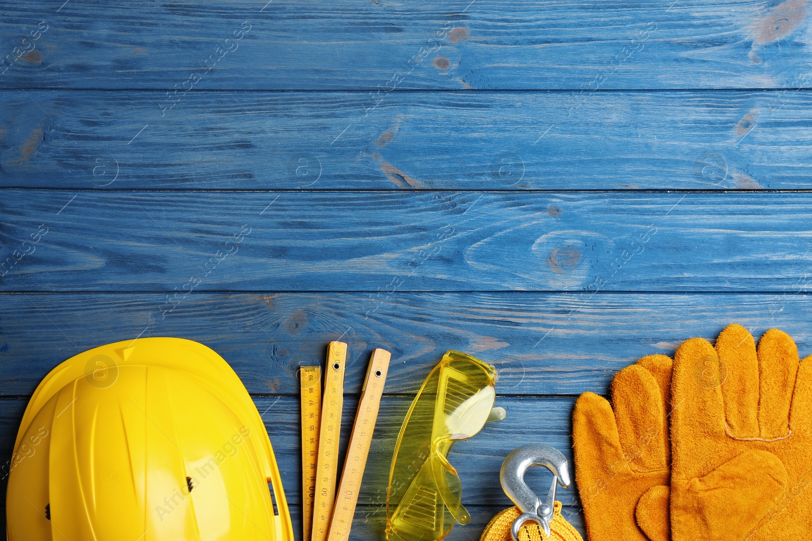 Photo of Flat lay composition with different construction tools and space for text on color wooden background