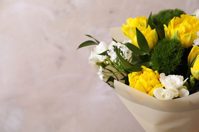 Beautiful bouquet with peony tulips on beige background, closeup. Space for text