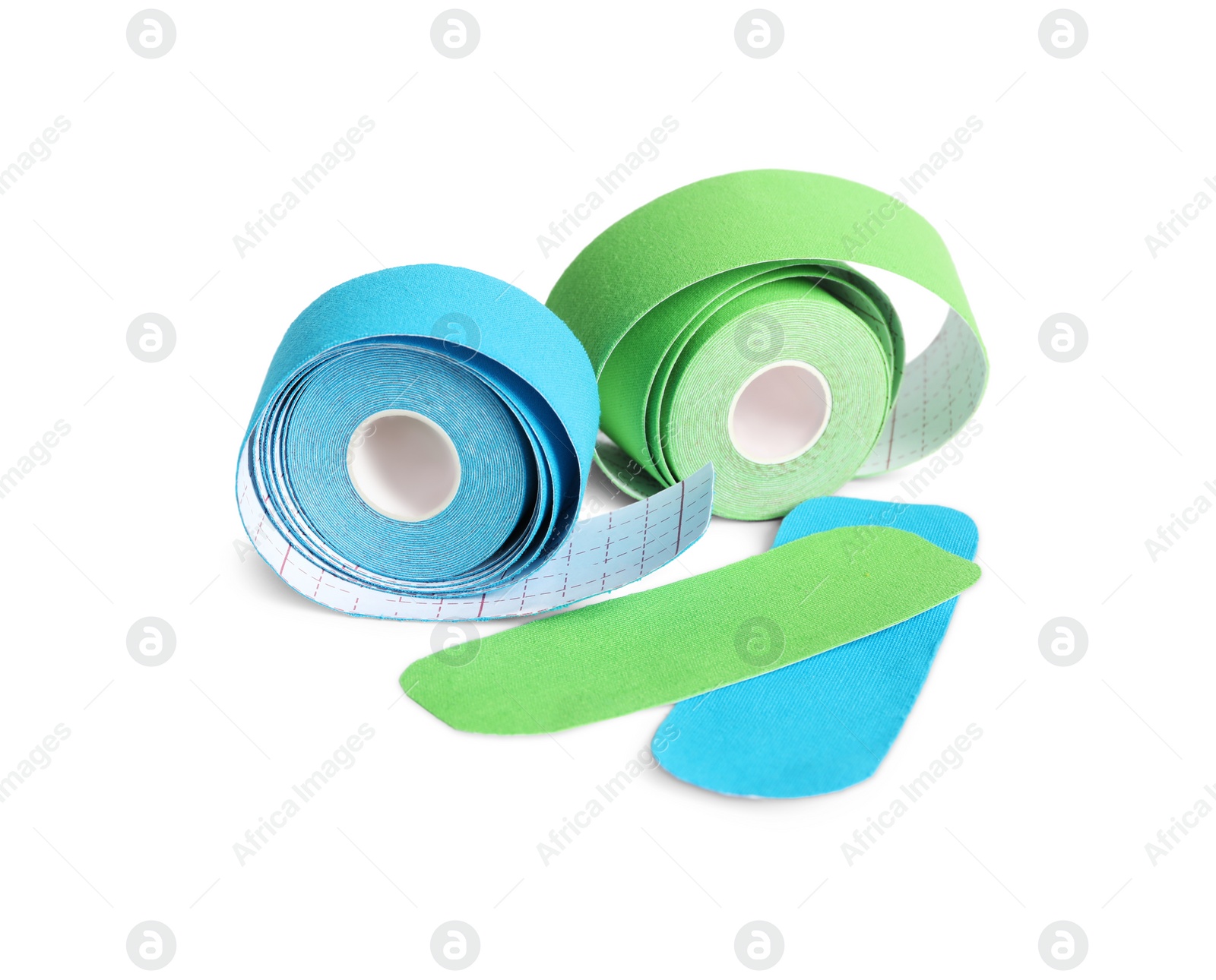 Photo of Bright kinesio tape rolls and pieces on white background, space for text