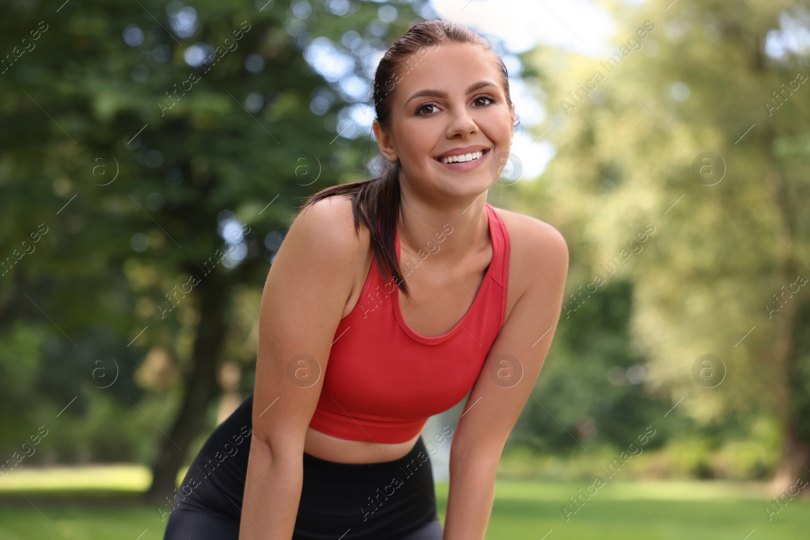 Photo of Portrait of smiling woman wearing sportswear in park