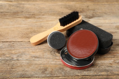 Photo of Composition with shoe care accessories on wooden background, closeup