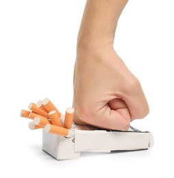 Photo of Stop smoking. Man crushing pack with cigarettes on white background, closeup