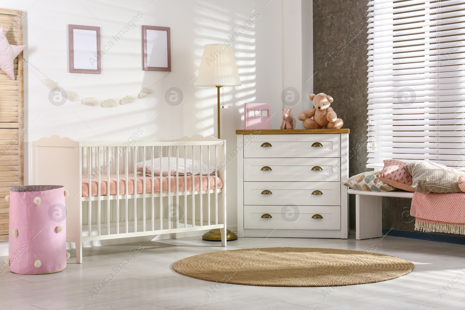 Photo of Cozy baby room interior with comfortable crib