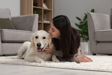 Happy woman with cute Labrador Retriever dog on floor at home. Adorable pet