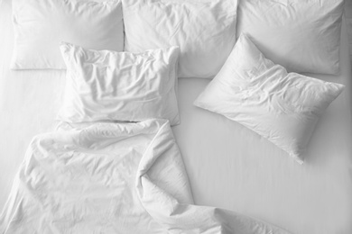 Soft pillows on comfortable bed, top view