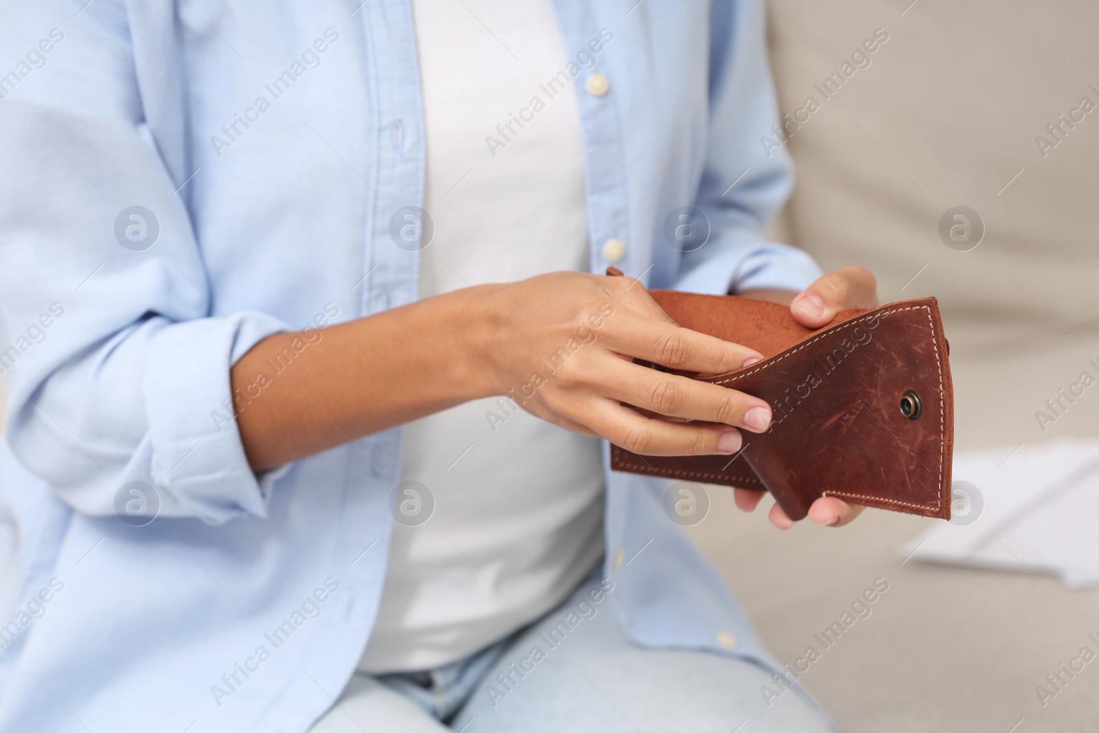 Photo of Woman with empty wallet indoors, closeup. Debt problem