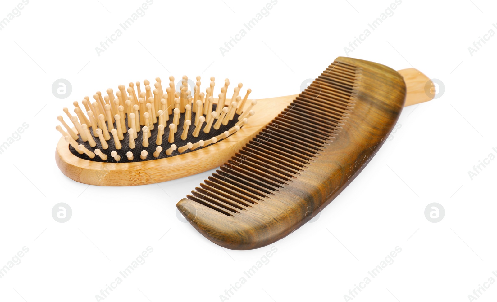 Photo of New wooden hair brush and comb isolated on white