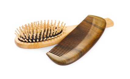 Photo of New wooden hair brush and comb isolated on white