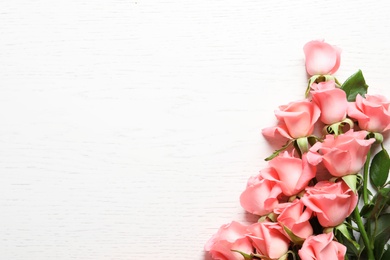 Photo of Beautiful roses on wooden table