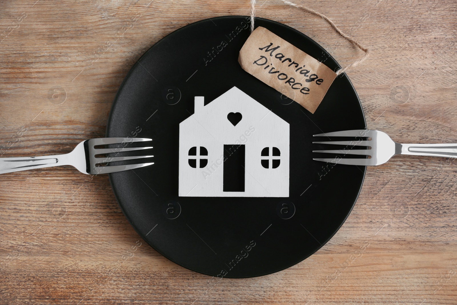 Photo of Divorce concept. Plate with model of house, paper card and forks on wooden table, flat lay